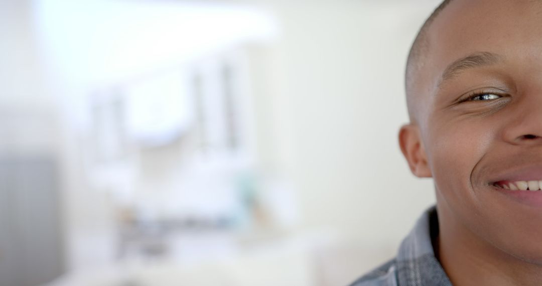 Close-Up of Smiling Young African American Man in Modern Home - Free Images, Stock Photos and Pictures on Pikwizard.com