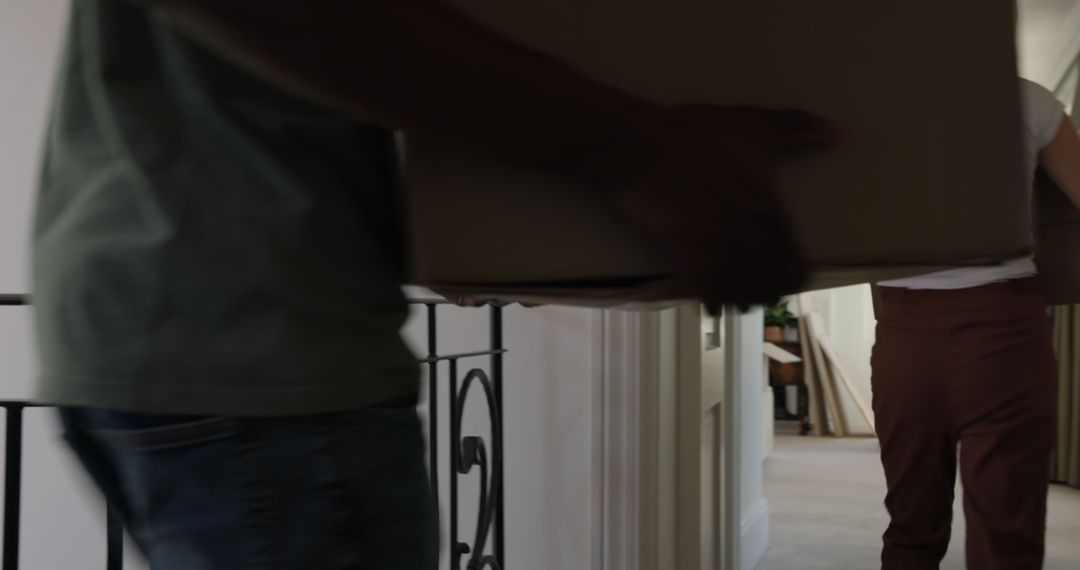 Couple Unpacking Boxes During New Home Relocation