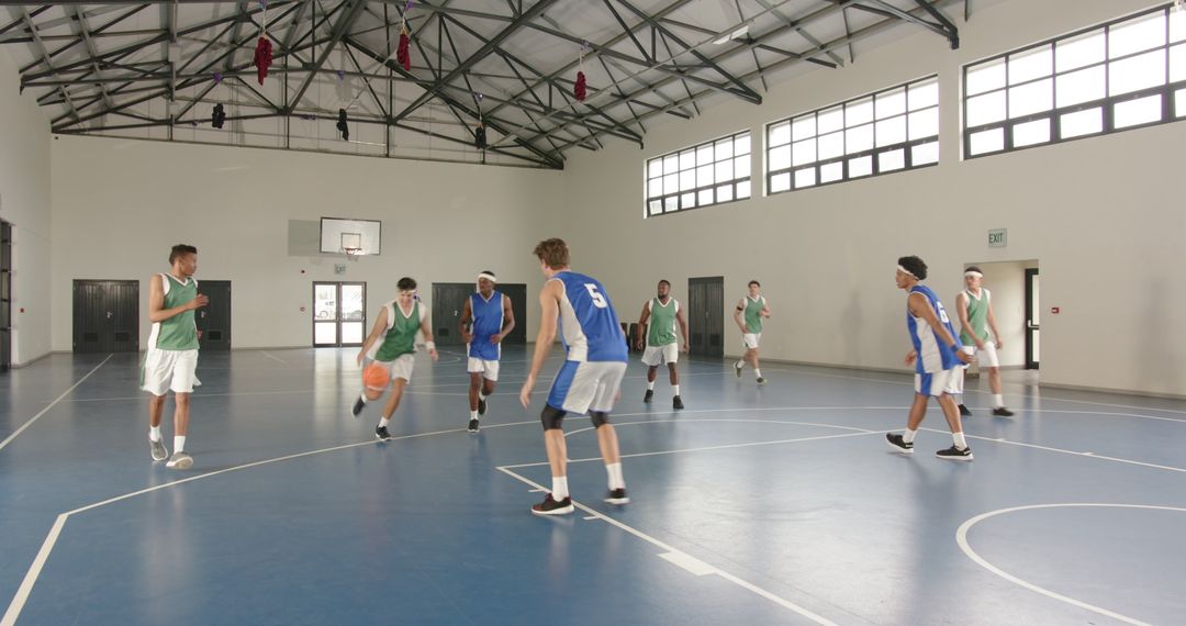 Basketball Team Practicing Intense Game in Indoor Gym