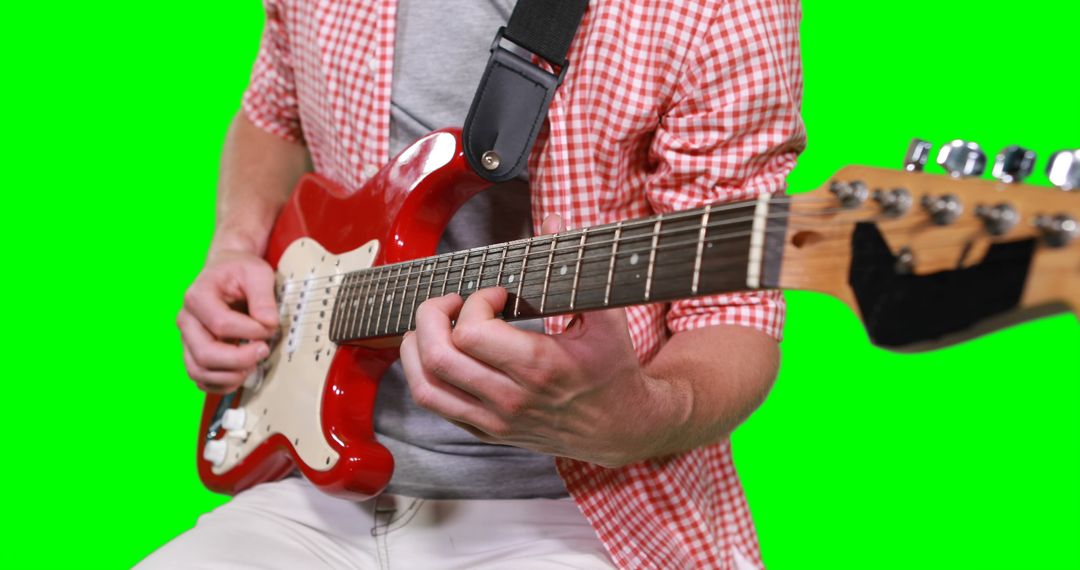 Person Playing Red Electric Guitar on Green Screen Background - Free Images, Stock Photos and Pictures on Pikwizard.com