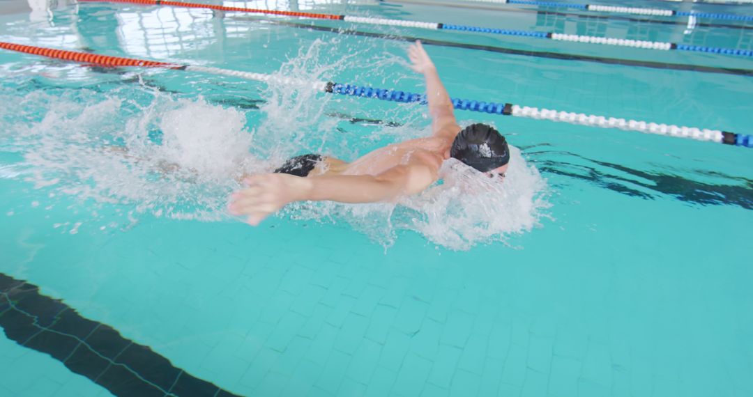 Competitive Swimmer Performing Butterfly Stroke - Free Images, Stock Photos and Pictures on Pikwizard.com