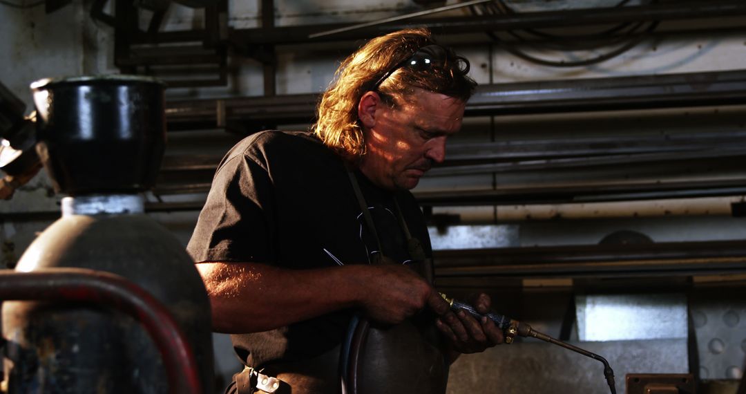 Focused Male Welder Working in Industrial Workshop - Free Images, Stock Photos and Pictures on Pikwizard.com