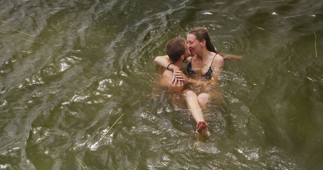 Couple Embracing While Swimming in Natural Lake - Free Images, Stock Photos and Pictures on Pikwizard.com