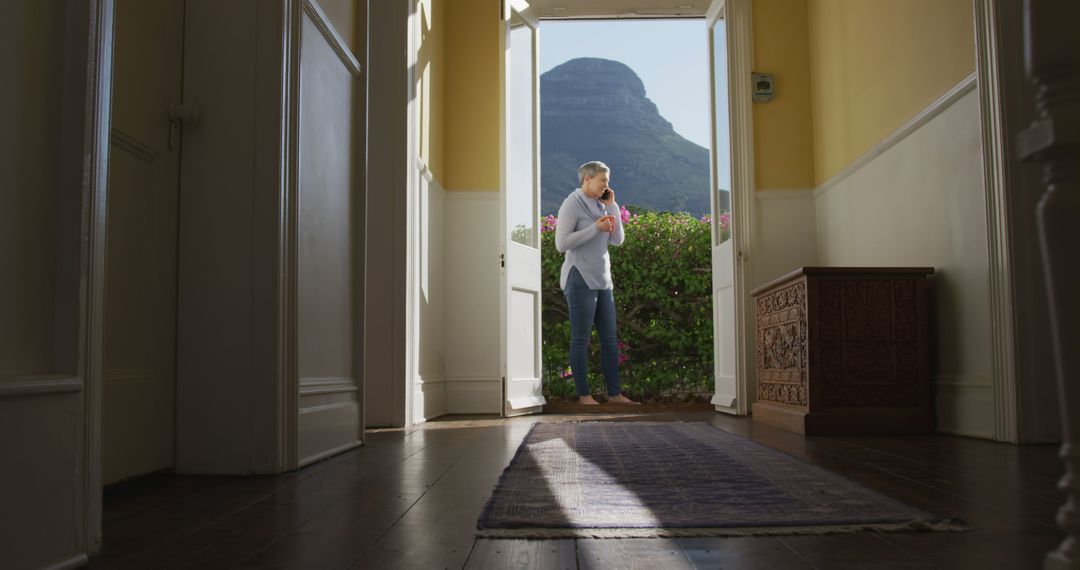 Man Reflecting in Sunny Interior Space with Mountain View - Free Images, Stock Photos and Pictures on Pikwizard.com