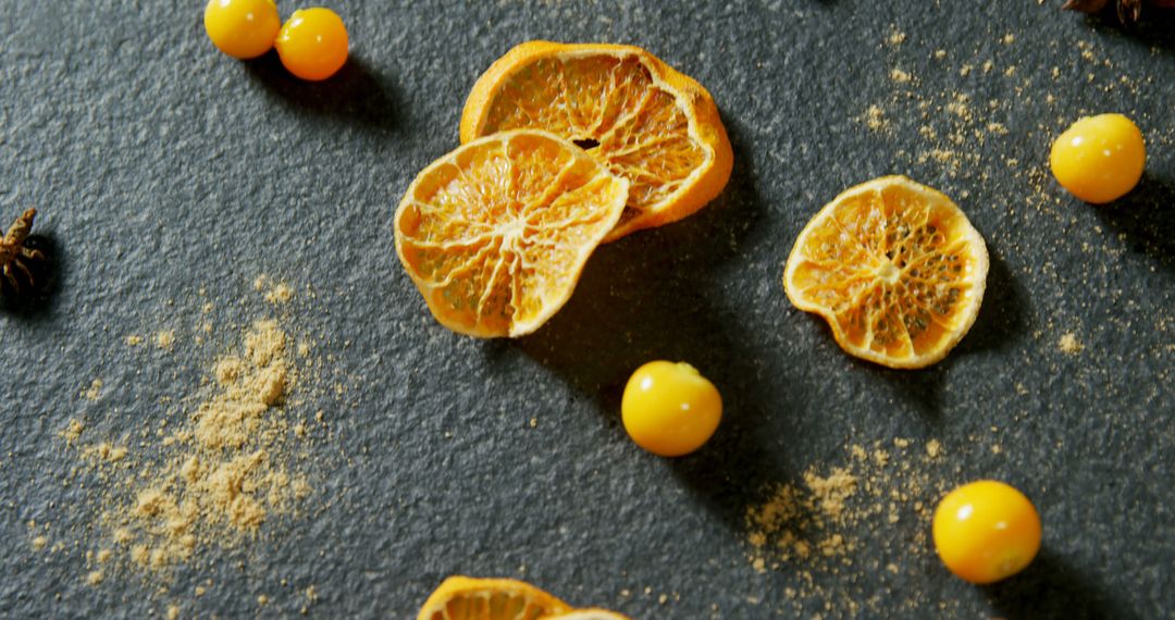 Dried Citrus Slices and Yellow Berries on Dark Slate Background - Free Images, Stock Photos and Pictures on Pikwizard.com