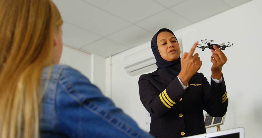 Female Pilot Demonstrating Drone to Curious Student in Classroom - Free Images, Stock Photos and Pictures on Pikwizard.com