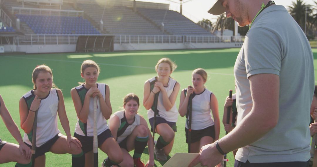 Female Field Hockey Team Receiving Instructions from Coach - Free Images, Stock Photos and Pictures on Pikwizard.com