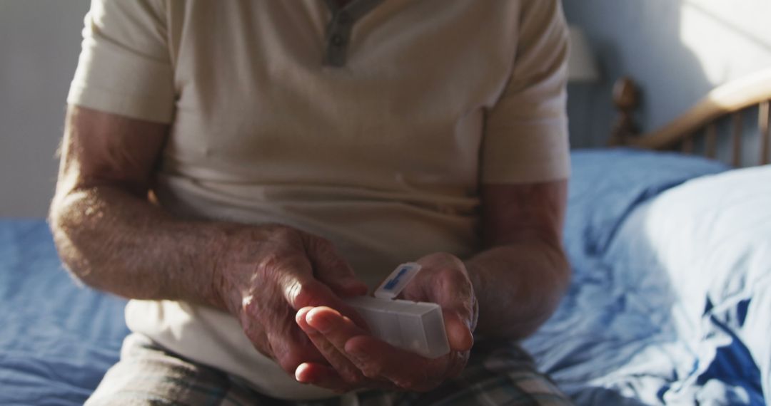 Senior Man Organizing Medication in Pill Box at Home - Free Images, Stock Photos and Pictures on Pikwizard.com