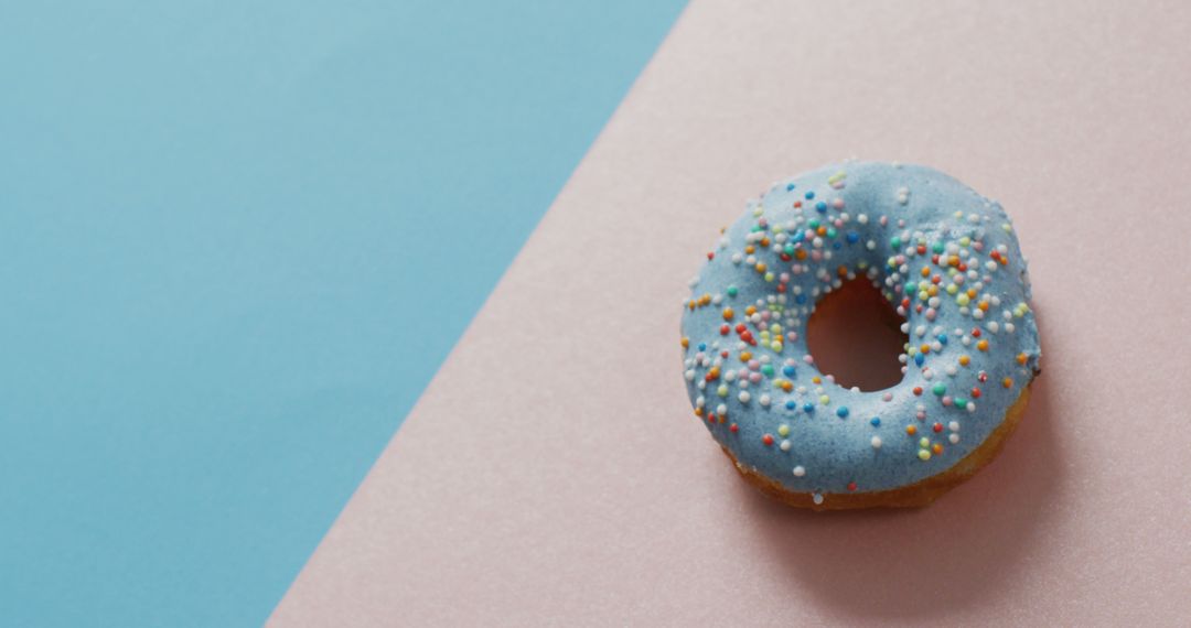 Blue Frosted Donut with Sprinkles on Pink and Blue Background - Free Images, Stock Photos and Pictures on Pikwizard.com