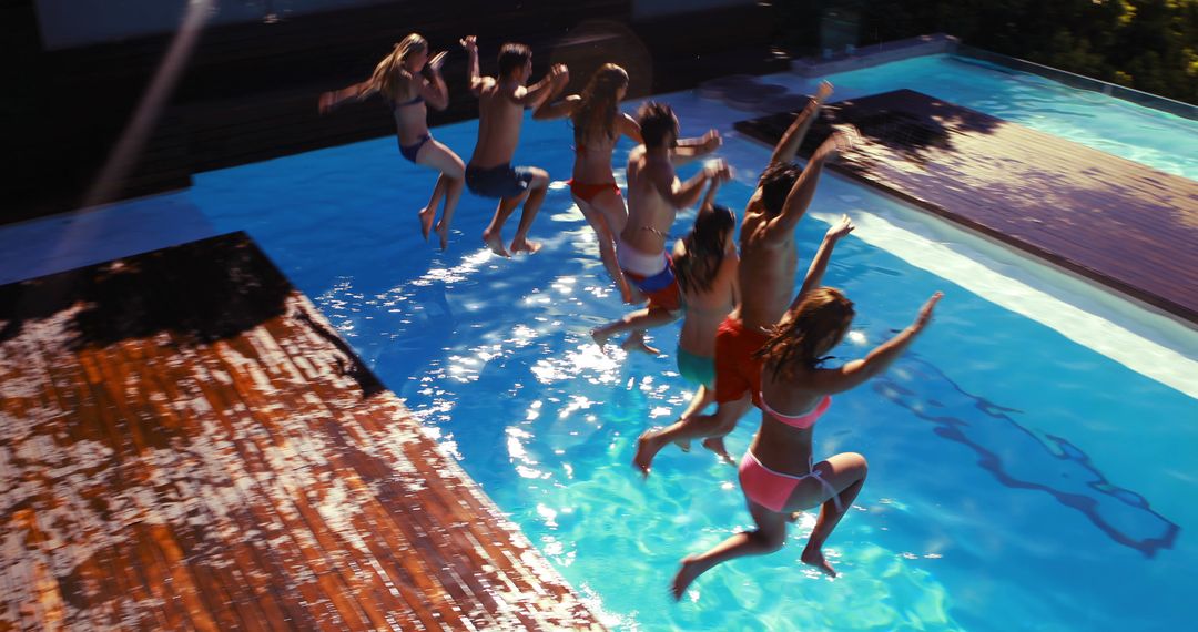 Group of Friends Jumping into Pool Enjoying Summer Vacation - Free Images, Stock Photos and Pictures on Pikwizard.com