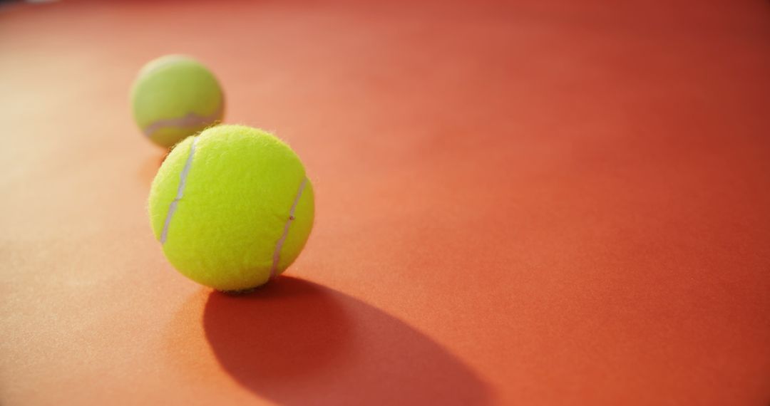 Tennis Balls on Red Court Surface with Shadows - Free Images, Stock Photos and Pictures on Pikwizard.com