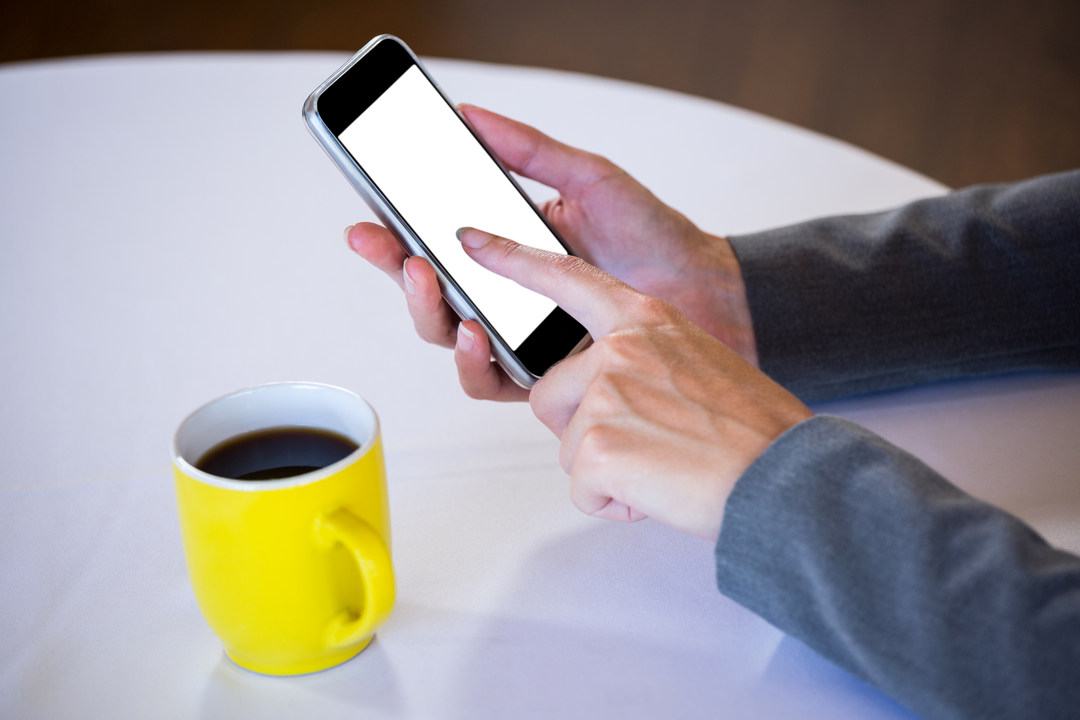 Woman Using Smartphone at Table with Coffee Cup - Download Free Stock Images Pikwizard.com