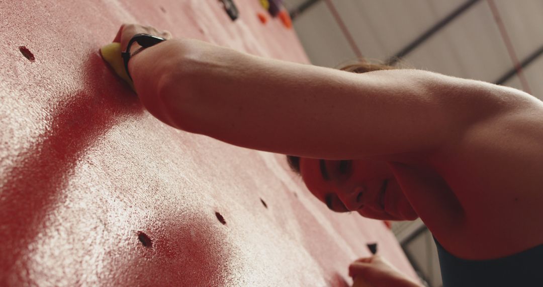 Woman Climbing Indoor Rock Wall, Focus on Strength and Grip - Free Images, Stock Photos and Pictures on Pikwizard.com