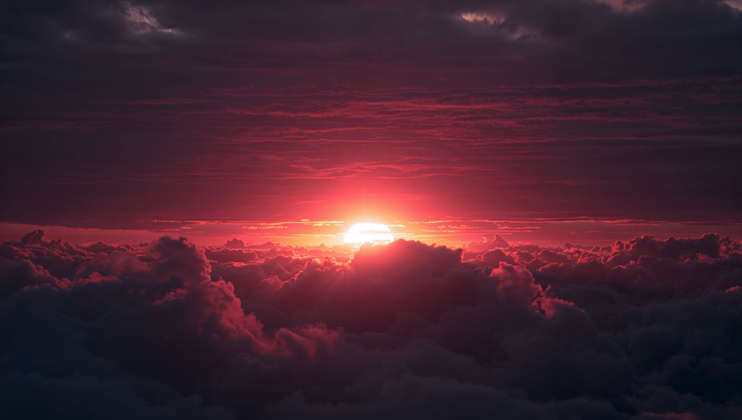 Crimson Sky Phenomenon Illuminates Billowing Clouds at Break of Dawn