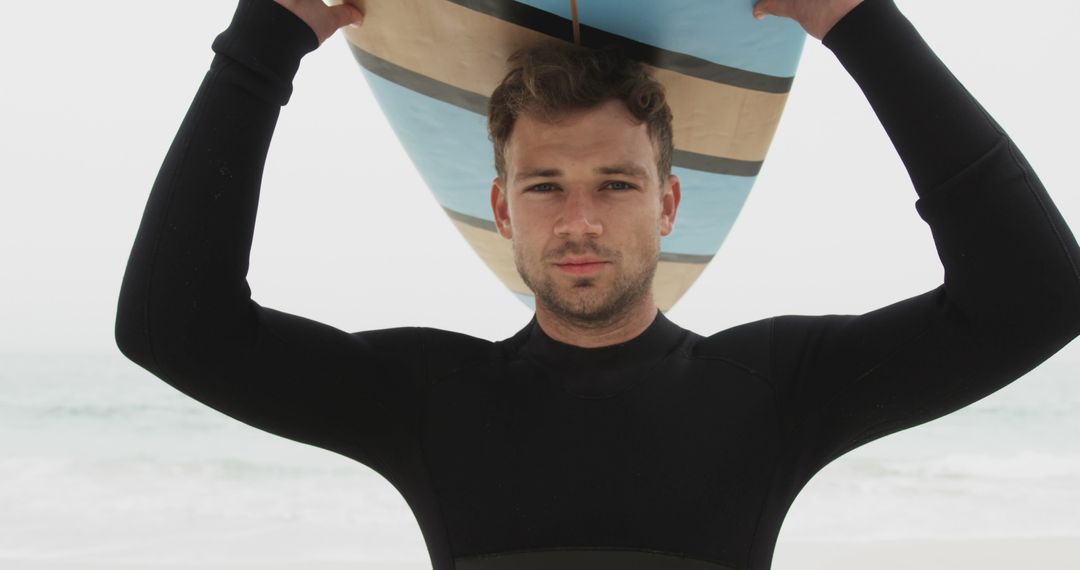 Confident Surfer Holding Board at Beach