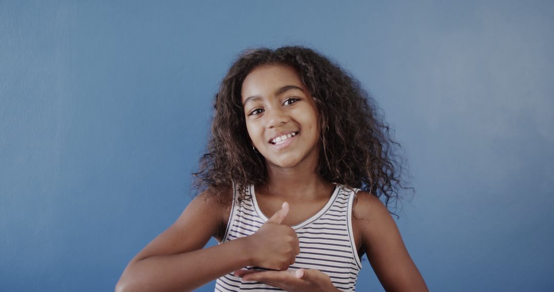 Smiling Biracial Girl Communicating in Sign Language