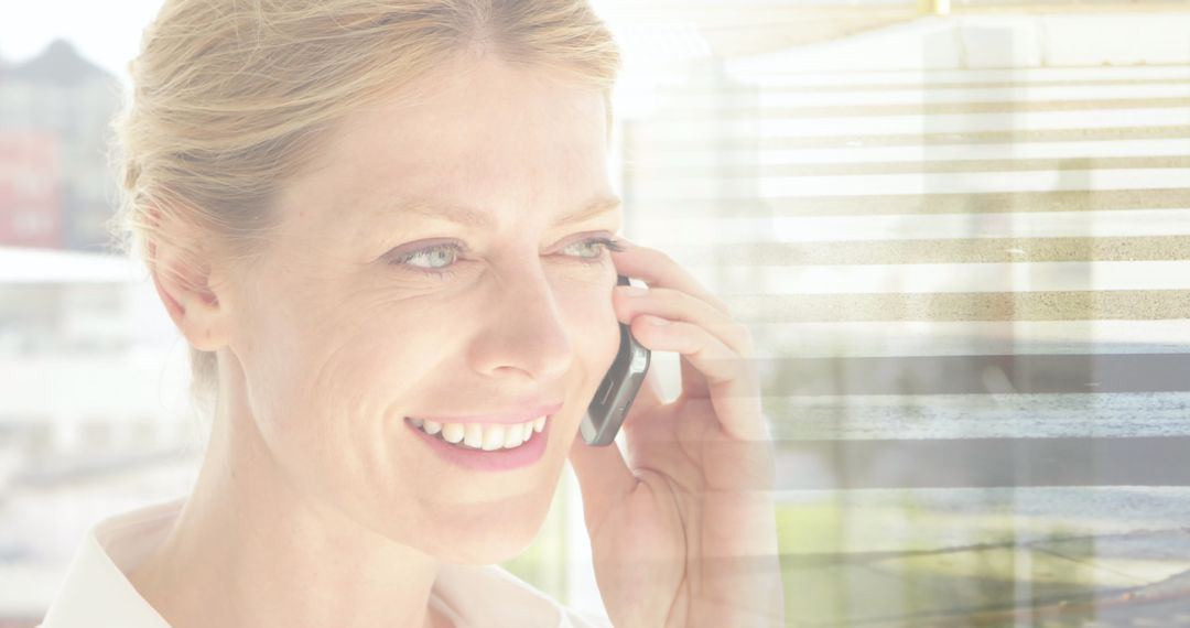 Smiling Businesswoman Talking on Smartphone with Cityscape Overlay