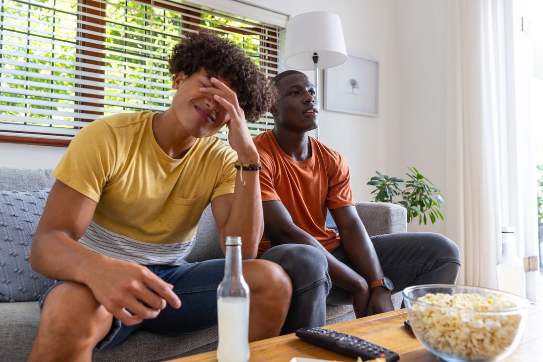 Diverse Friends Relaxing at Home with Popcorn and Drinks