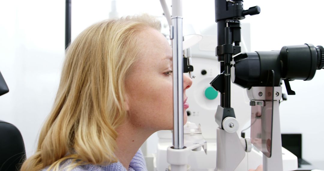 Woman Undergoing Eye Examination with Diagnostic Equipment - Free Images, Stock Photos and Pictures on Pikwizard.com