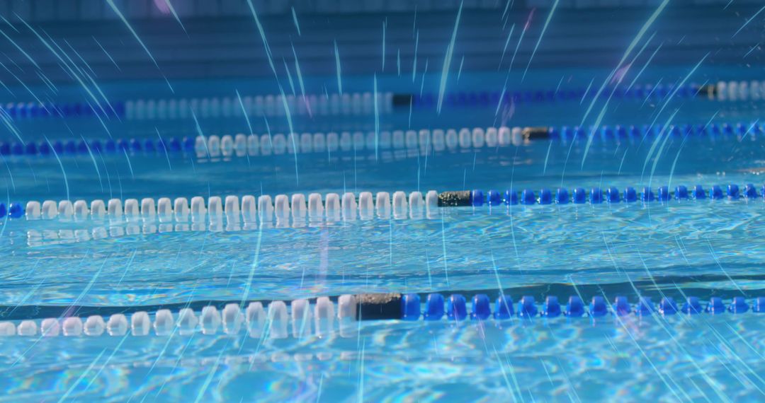 Sunlit Pool Surface with Rippling Blue Water and Lane Dividers