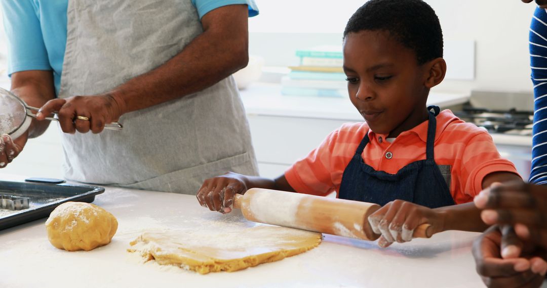 Young Boy Learning to Roll Dough with Family