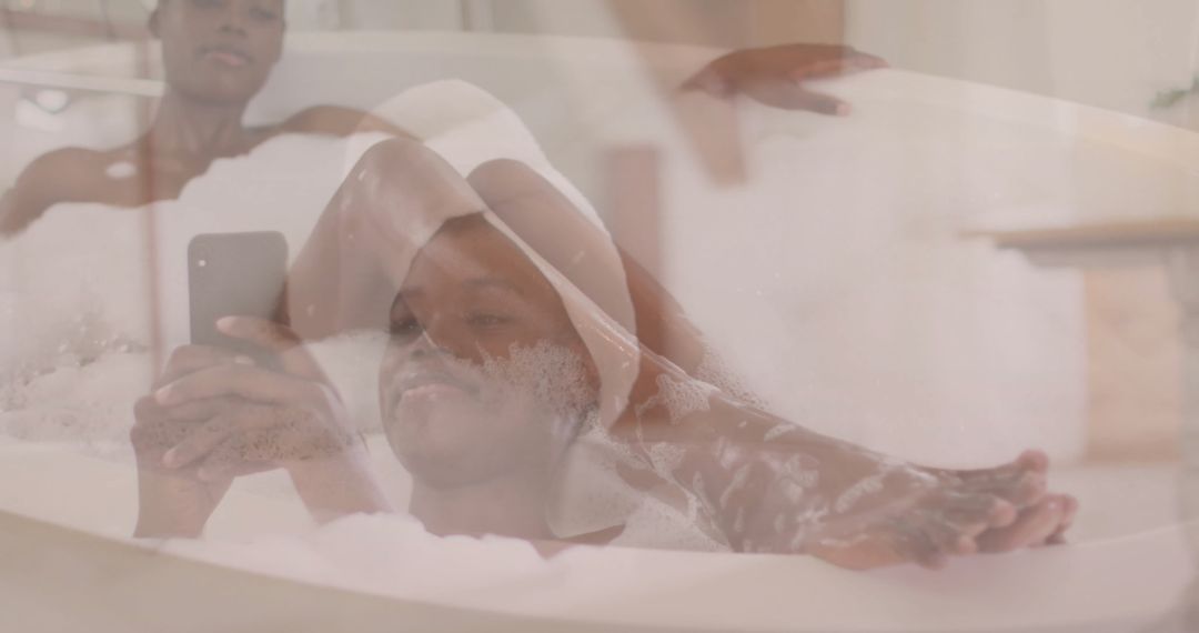 Woman Relaxing in Bubble Bath While Using Smartphone