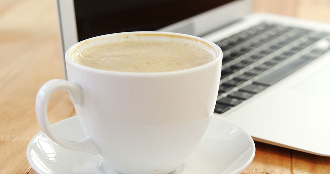 White Coffee Cup Near Laptop on Wooden Table - Free Images, Stock Photos and Pictures on Pikwizard.com