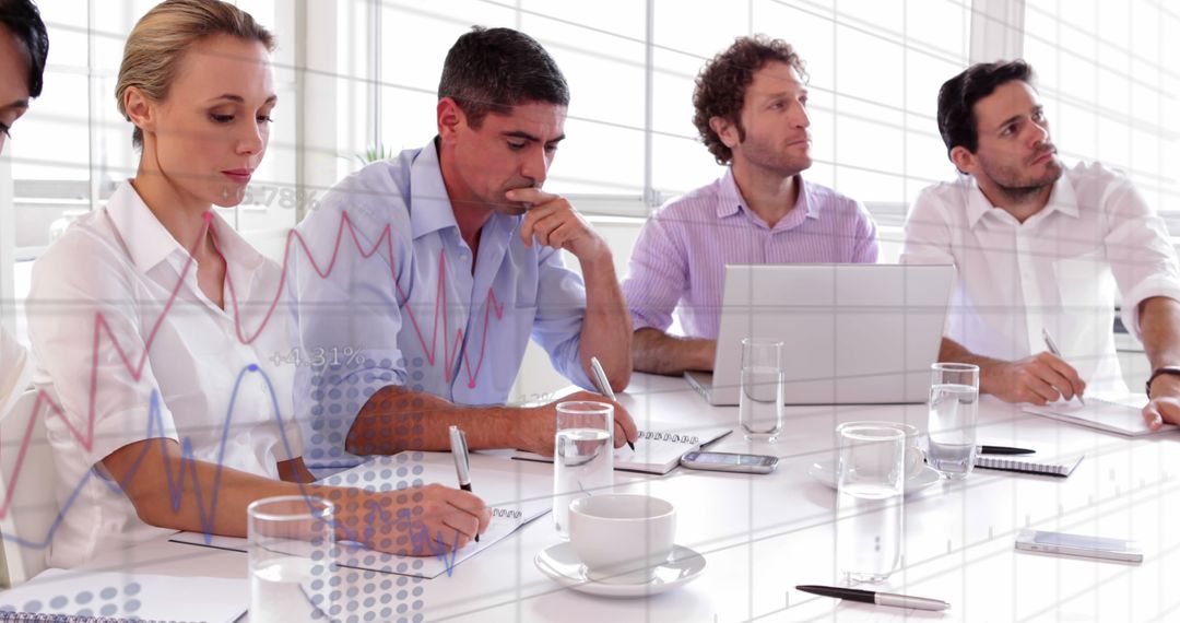 Diverse Business Team Analyzing Financial Data in Office Meeting