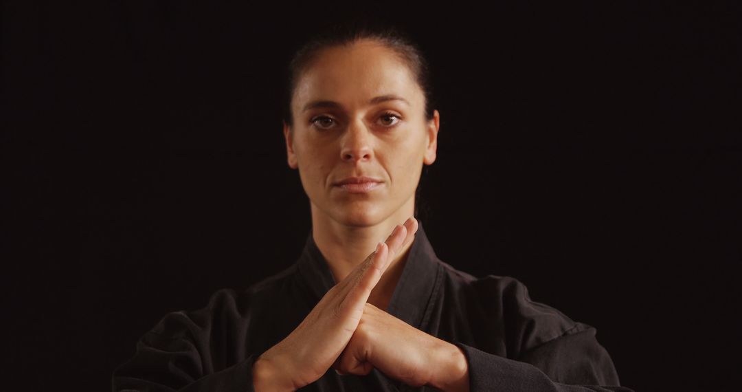 Female Martial Artist in Black Gi Demonstrating Focus and Discipline - Free Images, Stock Photos and Pictures on Pikwizard.com