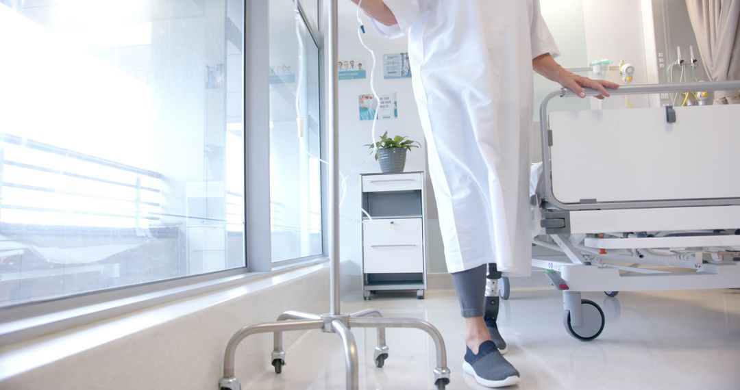 Hospital Patient with Prosthetic Leg Moving with IV Drip Stand - Free Images, Stock Photos and Pictures on Pikwizard.com