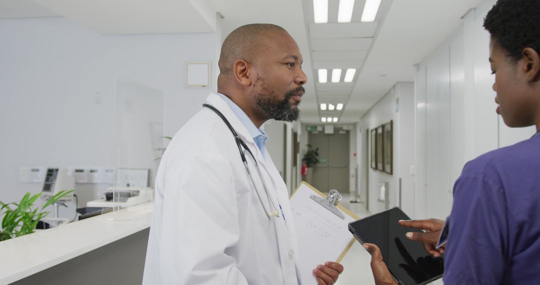 Doctor and Nurse Discussing Patient Information in Modern Hospital - Free Images, Stock Photos and Pictures on Pikwizard.com