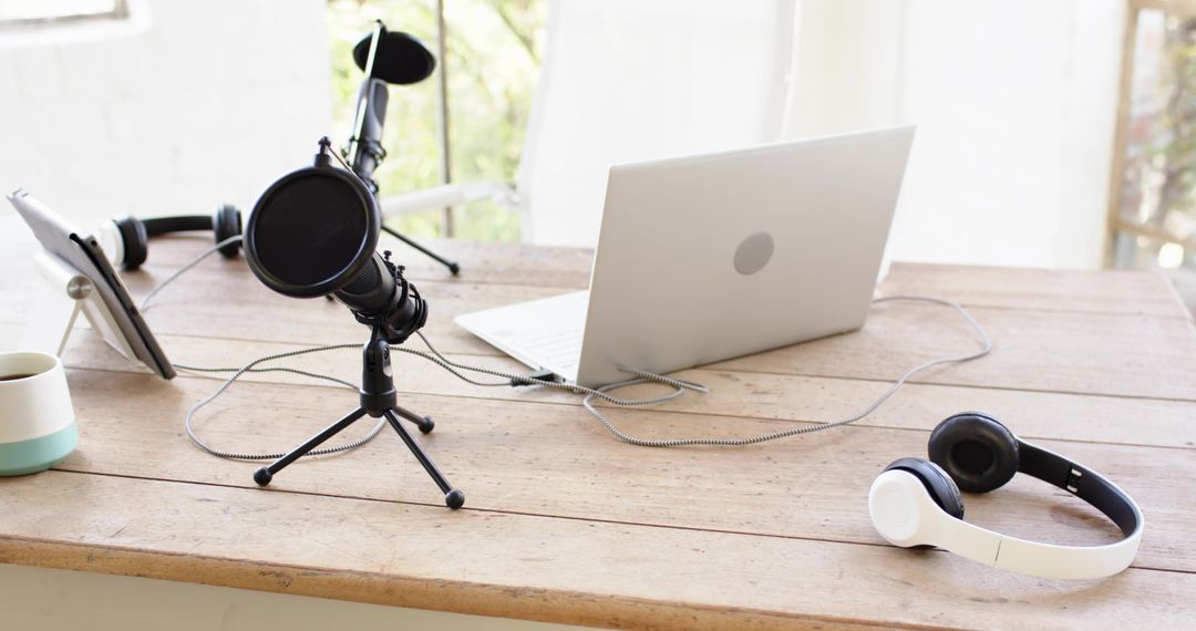 Minimalist Recording Workspace with Microphone and Laptop