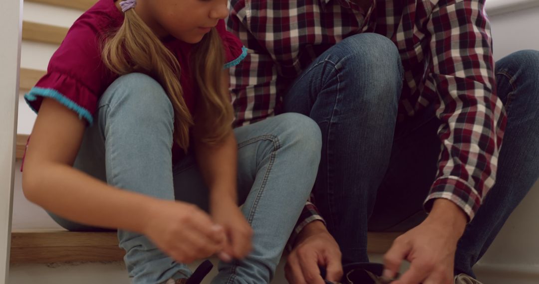 Father and Daughter Tying Shoelaces Together on Stairs - Free Images, Stock Photos and Pictures on Pikwizard.com