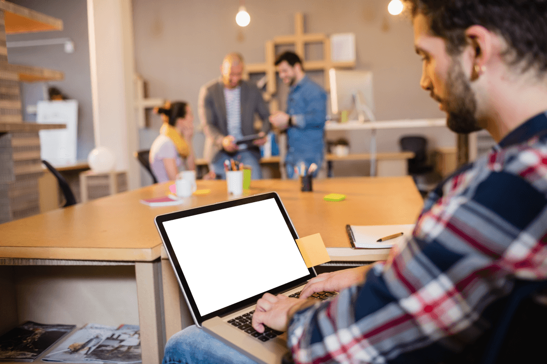 Designer at Laptop with Colleagues Collaborating in Transparent Office Space