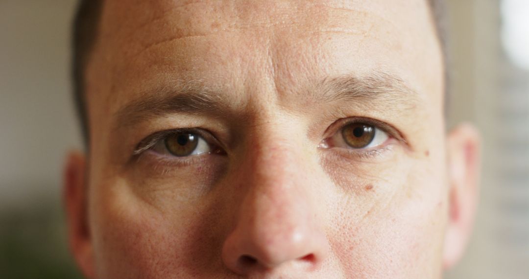 Close-Up of Man's Eyes with Introspective Gaze at Home