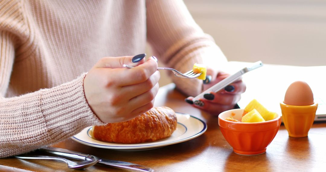 Woman Eating Breakfast While Using Smartphone - Free Images, Stock Photos and Pictures on Pikwizard.com