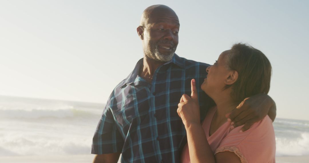 Senior African American couple enjoying walk on beach - Free Images, Stock Photos and Pictures on Pikwizard.com