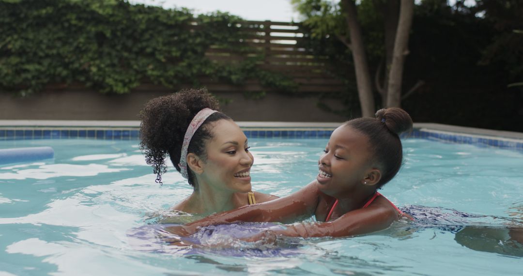 Mother Teaching Daughter to Swim in Outdoor Pool - Free Images, Stock Photos and Pictures on Pikwizard.com