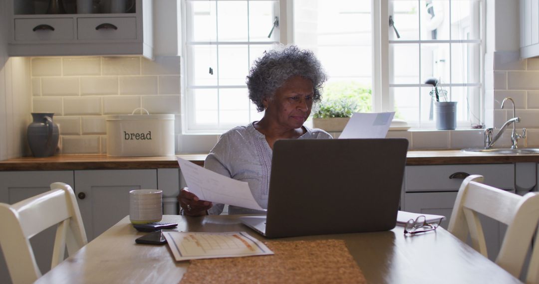 Senior Woman Managing Finances at Home with a Laptop - Free Images, Stock Photos and Pictures on Pikwizard.com