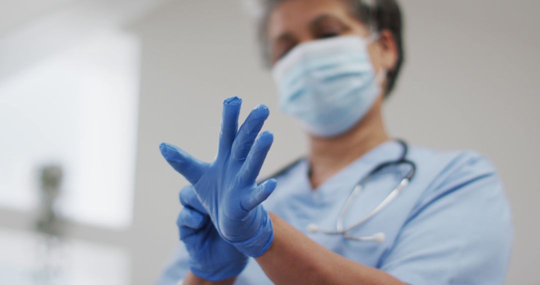 Doctor Wearing Blue Surgical Glove with Stethoscope in Clinic - Free Images, Stock Photos and Pictures on Pikwizard.com