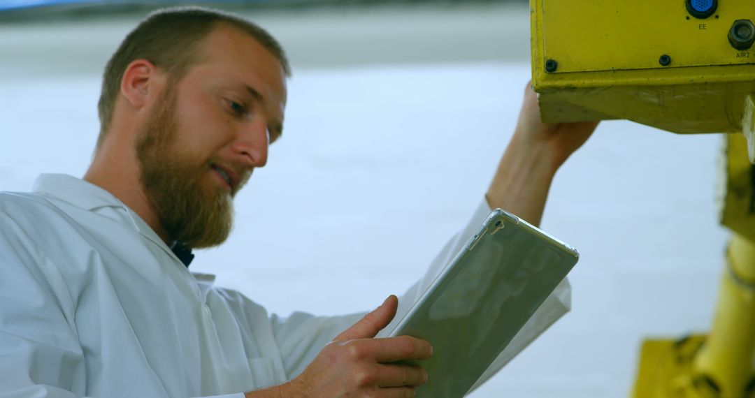 Engineer Inspecting Industrial Machine Using Tablet - Free Images, Stock Photos and Pictures on Pikwizard.com