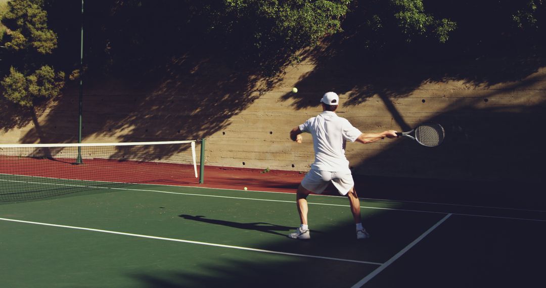 Male Tennis Player on Outdoor Court Preparing for a Forehand Shot - Free Images, Stock Photos and Pictures on Pikwizard.com