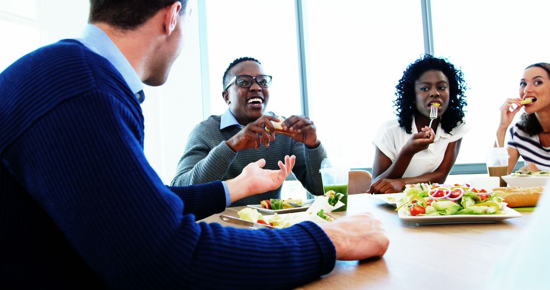 Coworkers Enjoying Lunch Together in Office Break Room - Free Images, Stock Photos and Pictures on Pikwizard.com