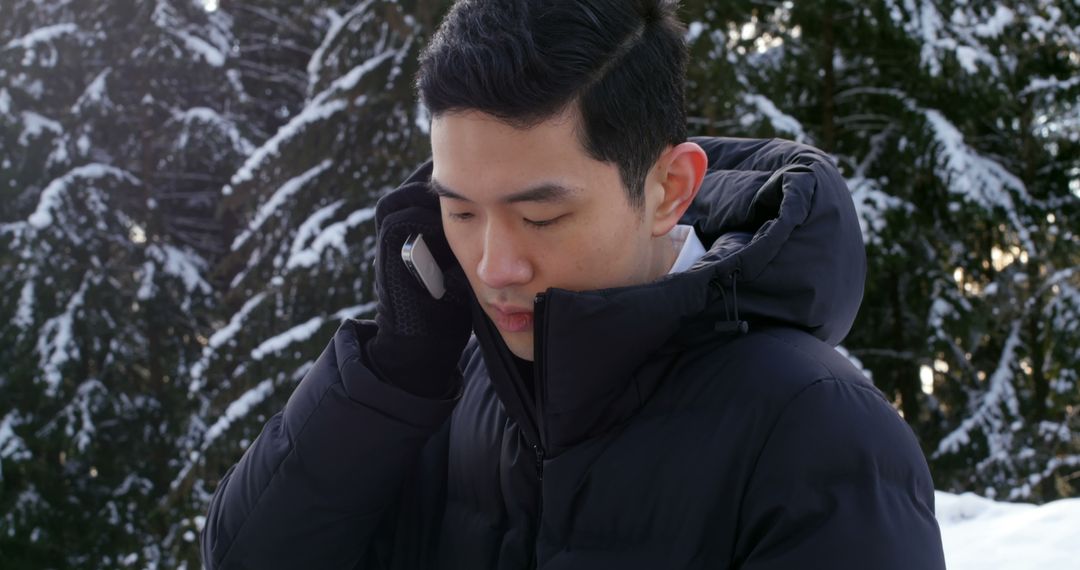 Young Man Talking on Phone in Snowy Forest - Free Images, Stock Photos and Pictures on Pikwizard.com