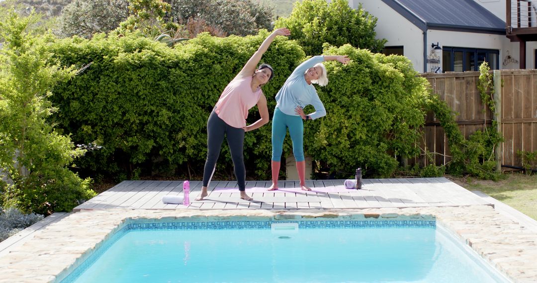 Senior Women Enjoying Fitness Routine by Backyard Poolside on Sunny Day - Free Images, Stock Photos and Pictures on Pikwizard.com