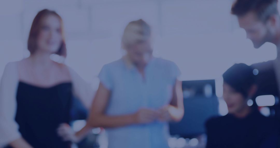 Team Collaborating in Bright Backlit Open-Plan Office Discussing Project Ideas