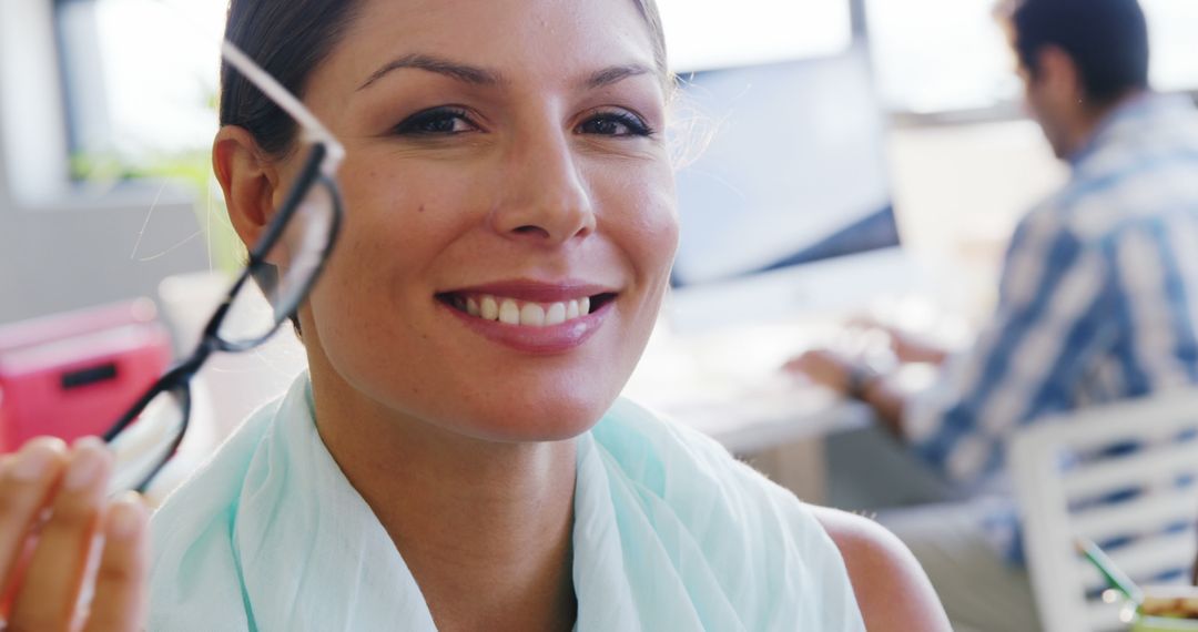 Confident Professional Woman Holding Glasses in Office - Free Images, Stock Photos and Pictures on Pikwizard.com