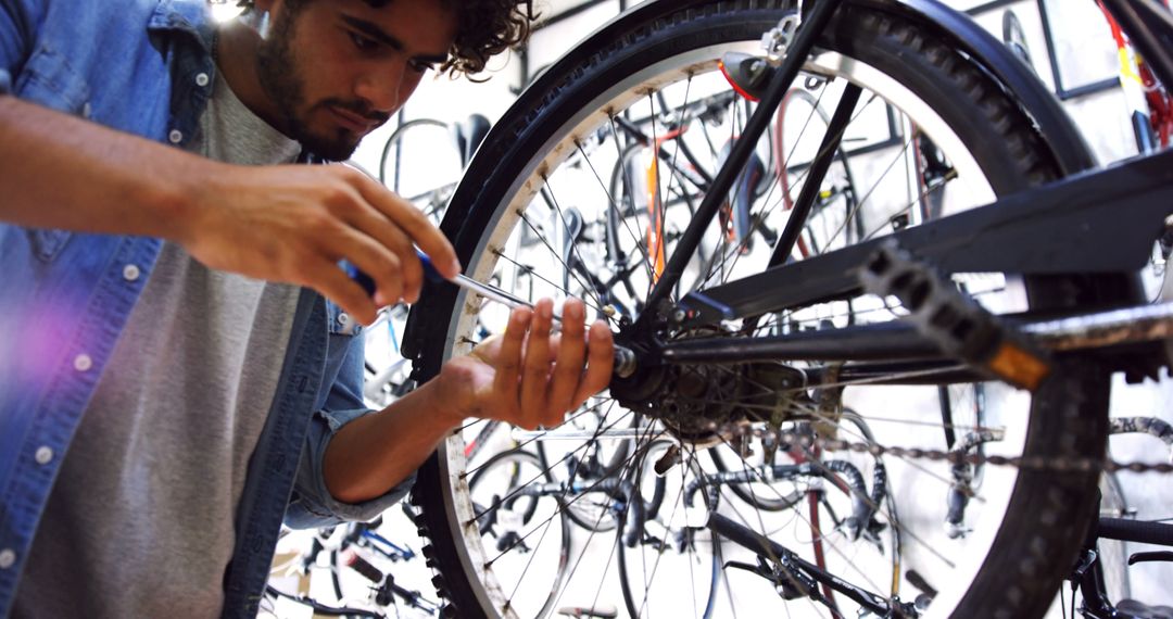 Skilled Mechanic Repairing Bicycle in Workshop