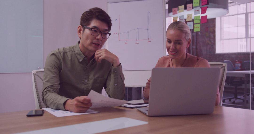 Colleagues Collaborating in a Modern Office with Technology Tools