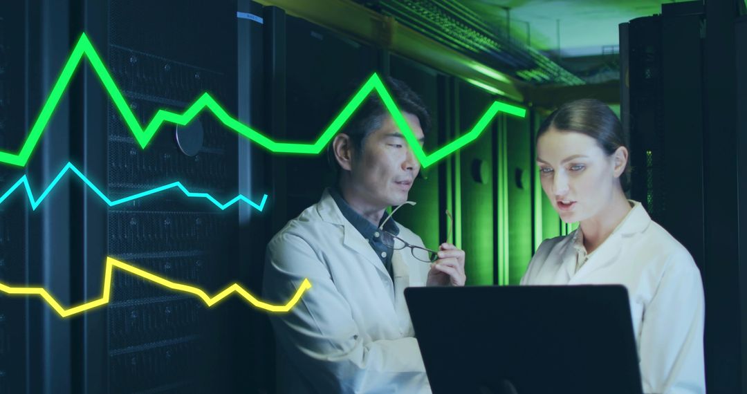 Engineers Analyzing Data with Digital Graphs in Modern Data Center
